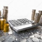 depositphotos_11069546-stock-photo-calculator-between-pile-of-coins.jpg